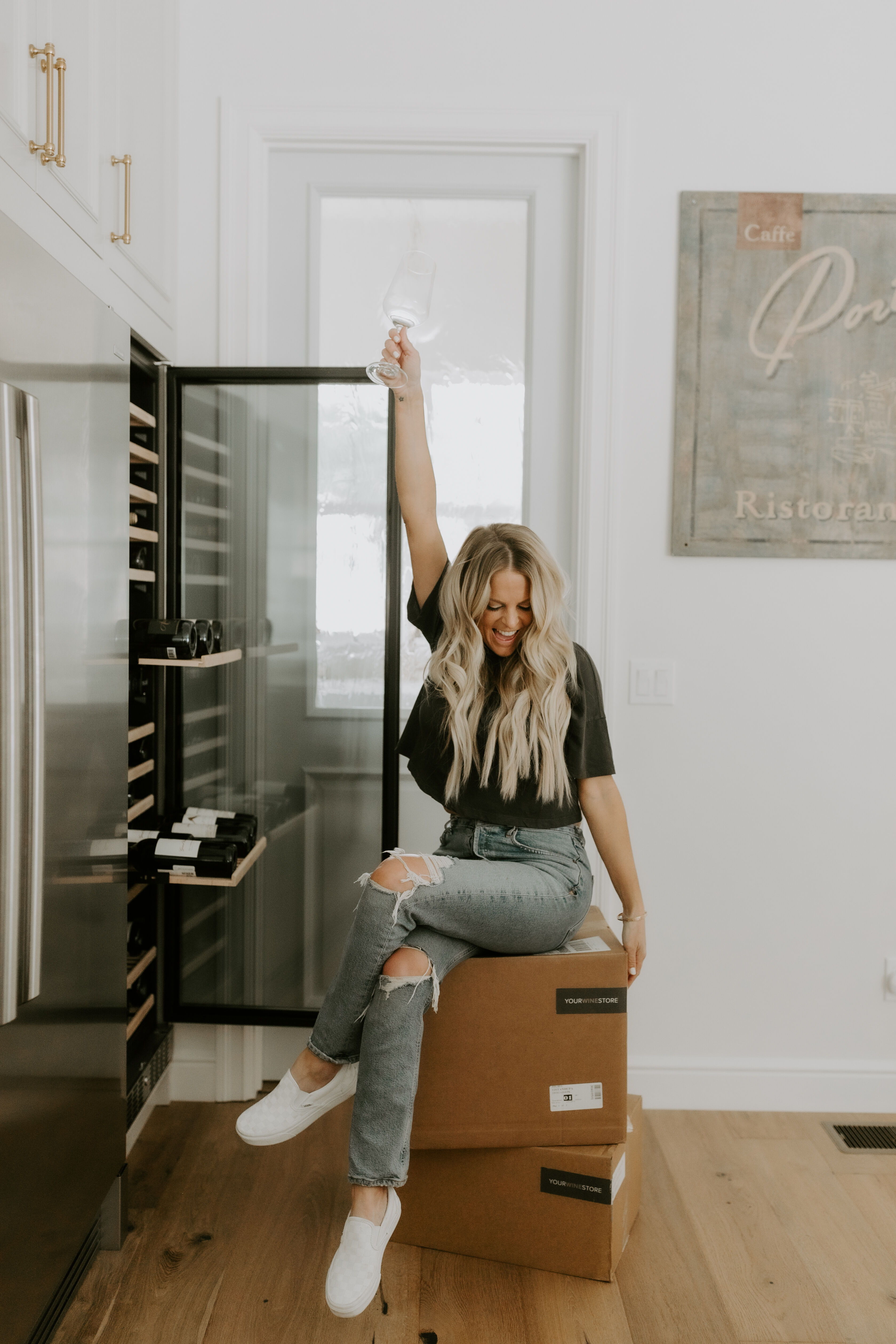 Erika standing with a glass of wine